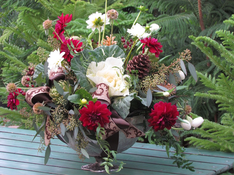Flowering kale with red dahlias and gold pinecones