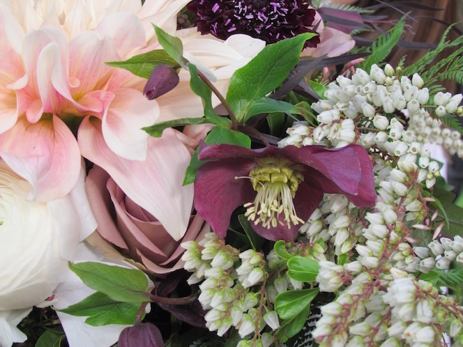 An open mauve Lenten Rose blossom accents this bridal bouquet