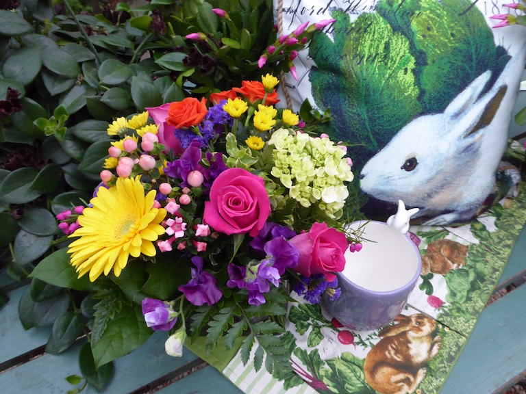 Bright pink roses and purple sweet peas with yellow gerberas for Easter